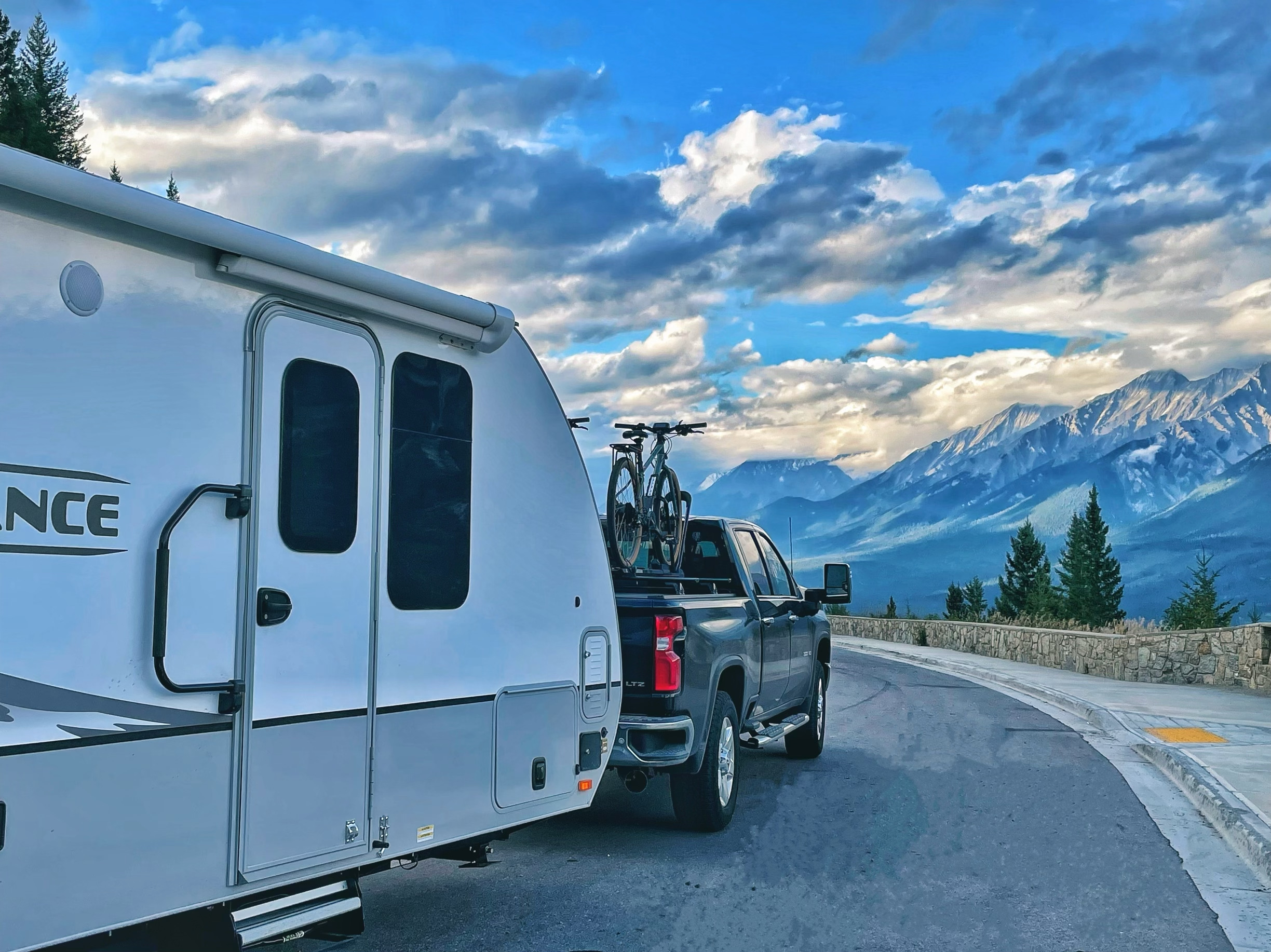 Towmads towing camping trailer with truck through Alberta Canada.