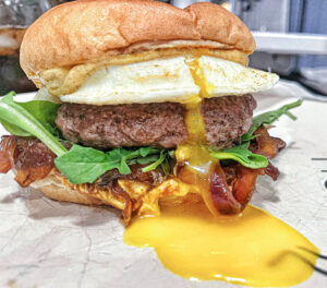 Runny yolk on lamb burger