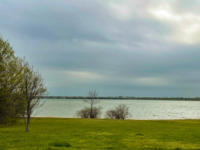 view of freeway across the water at Hickory Creek Campground in Hickory Creek TX