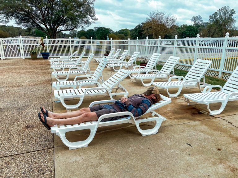 Tim resting on lounger by pool at Bayou Wilderness RV Campground in Carencro LA