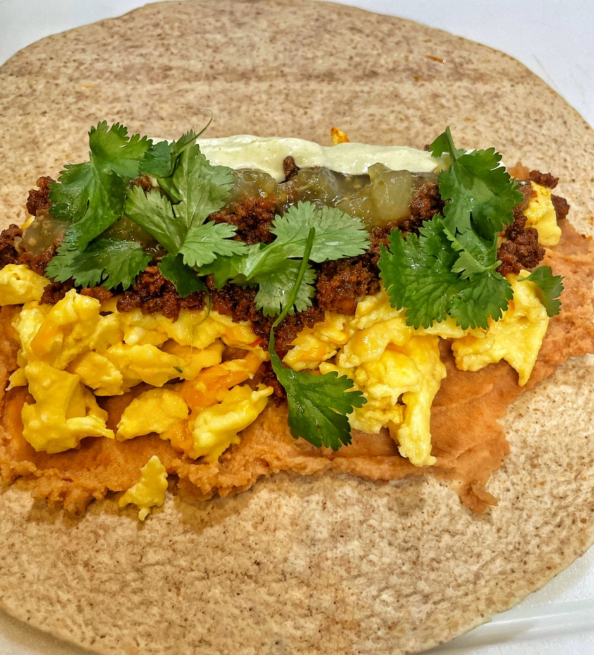 Adding Cilantro to Breakfast Burrito